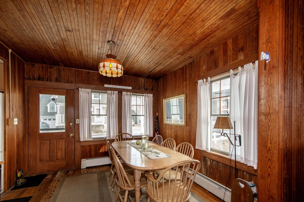 42 Lighthouse Road Scituate, MA 02066 - Photo 16 of 27 a dining room with furniture a chandelier and wooden floor