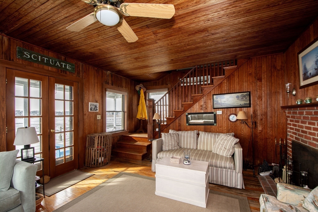 42 Lighthouse Road Scituate, MA 02066 - Photo 19 of 27 a living room with furniture a ceiling fan and a flat screen tv