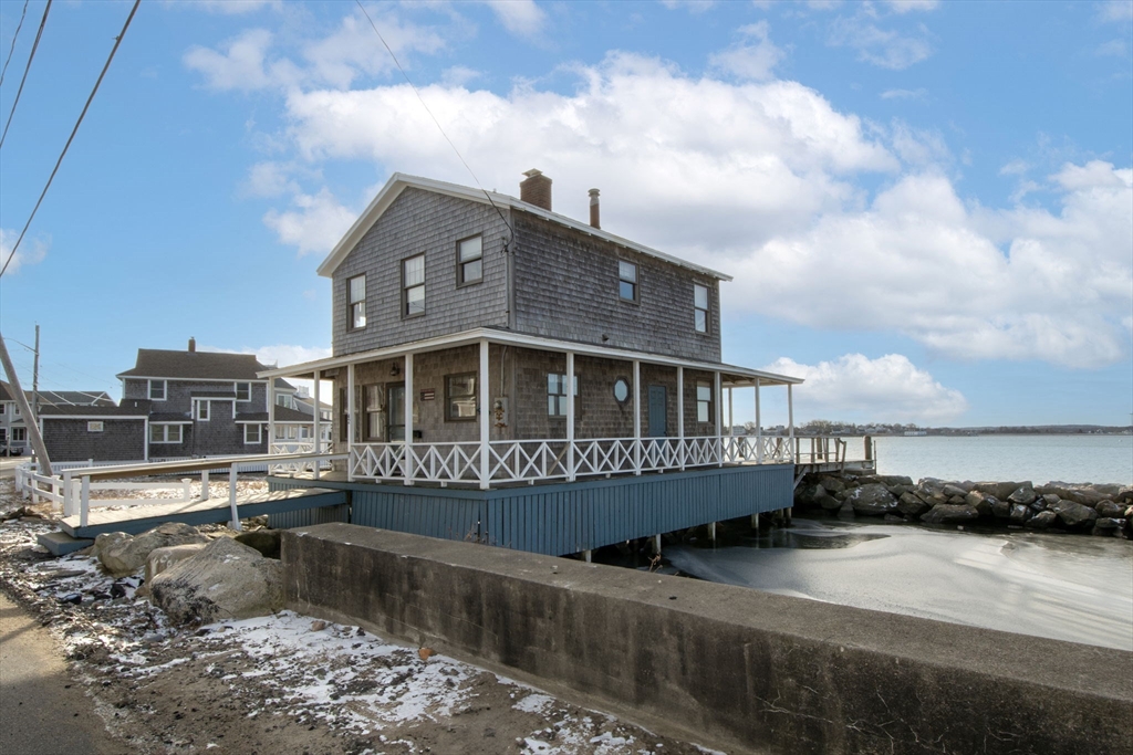 42 Lighthouse Road Scituate, MA 02066 - Photo 4 of 27 a front view of a house with a yard