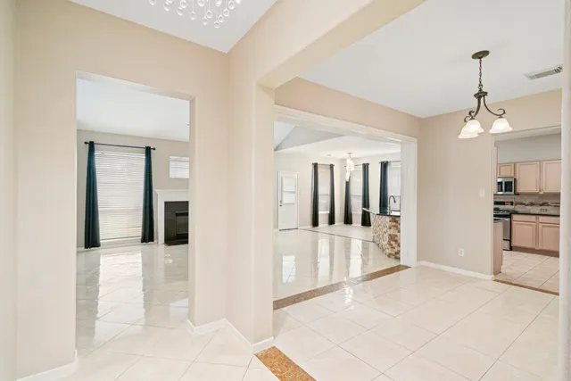 a view of a kitchen with a sink and a refrigerator