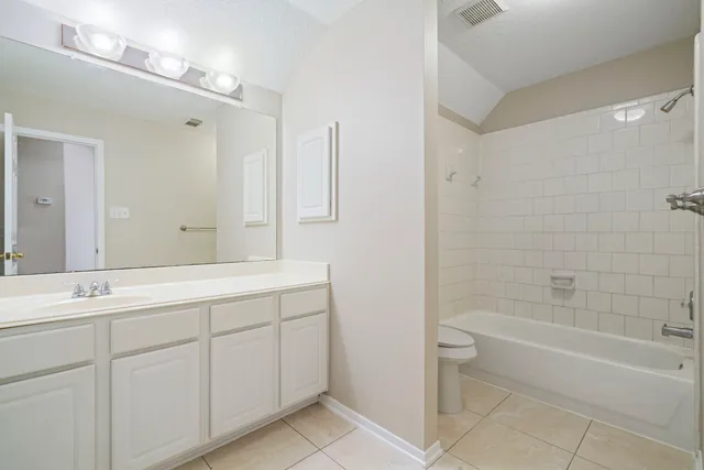a bathroom with a tub sink and mirror