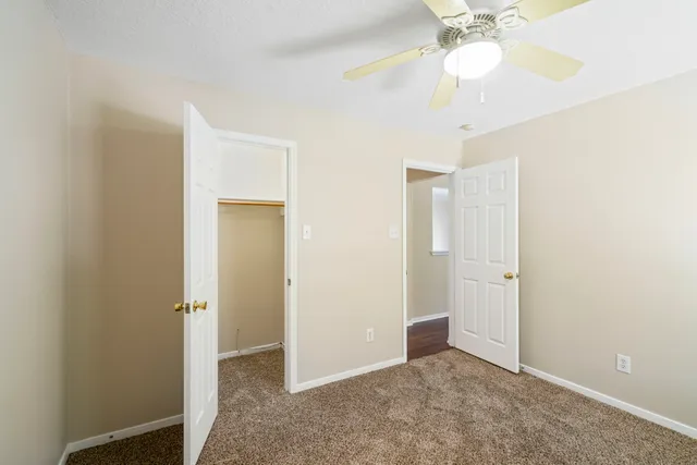 a view of an empty room with a fan