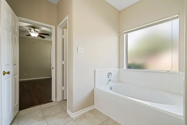 a white bath tub sitting next to a bathroom sink