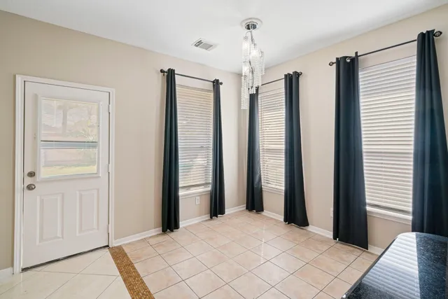a bedroom with windows and closet
