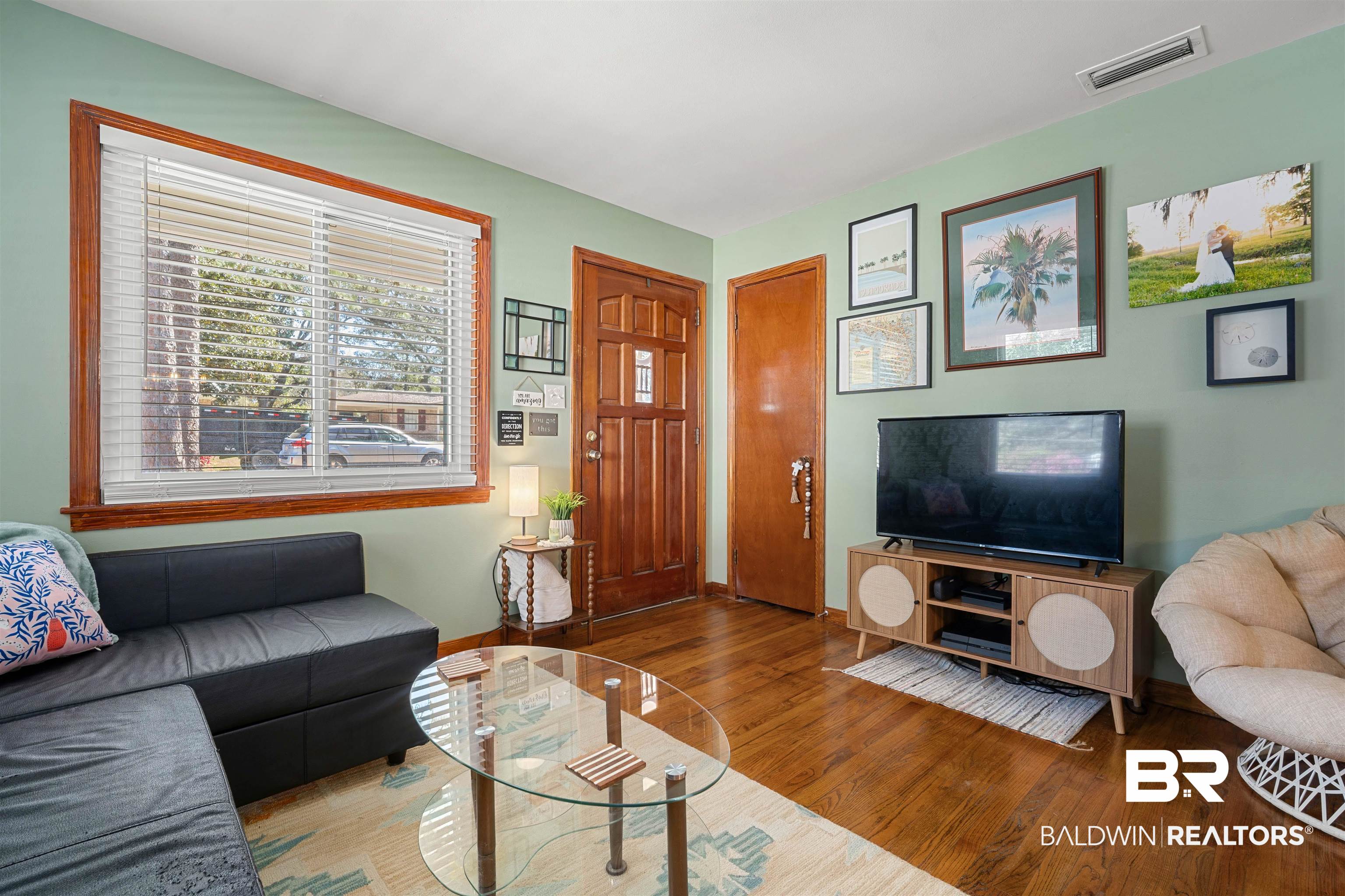 672 Tarawa Drive Mobile, AL 36609 - Photo 7 of 26 Living room featuring wood finished floors and baseboards