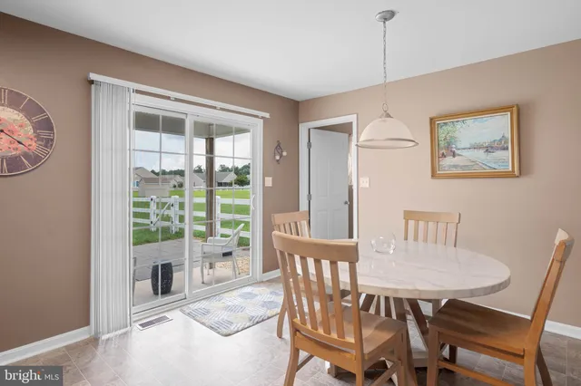 a view of a dining room with furniture large windows and wooden floor