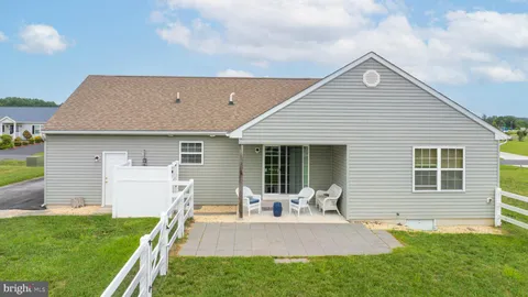 a front view of house with a garden and patio
