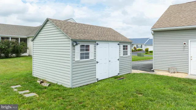 a view of a house with a yard and chair