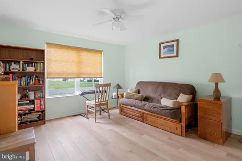 a living room with furniture and a book shelf