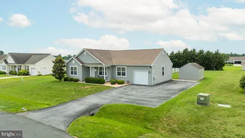 a aerial view of a house with a yard and garage