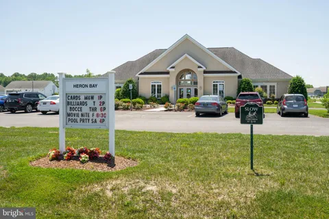 a room with pool table and windows
