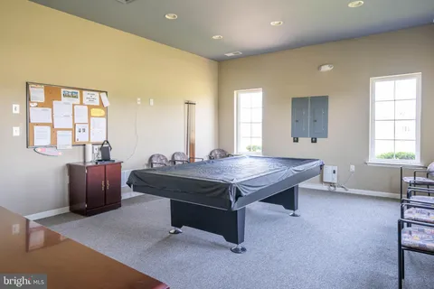 a kitchen with stainless steel appliances granite countertop a refrigerator a stove a sink and dishwasher