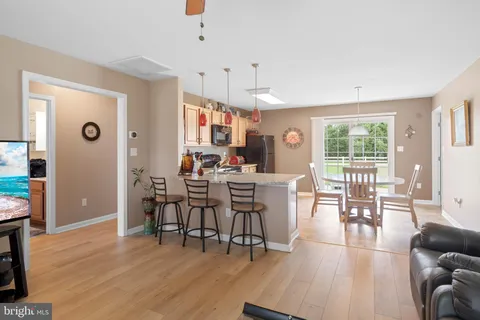 a view of a a dining room with furniture window and wooden floor