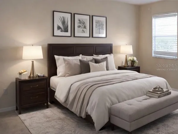 a bedroom with a bed and lamp