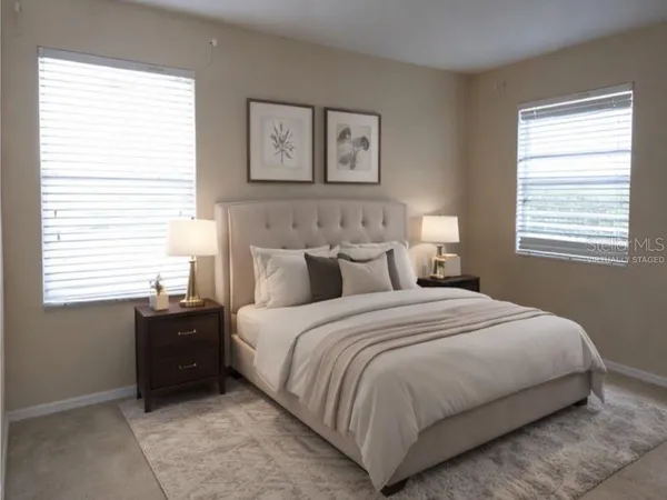 a bedroom with a bed and a window