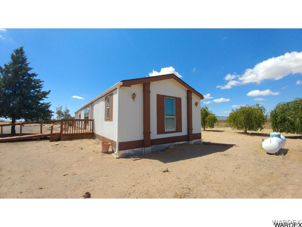4905 Teddy Roosevelt Road Golden Valley, AZ 86413 - Photo 2 of 29 a black and white photo of a house with a yard