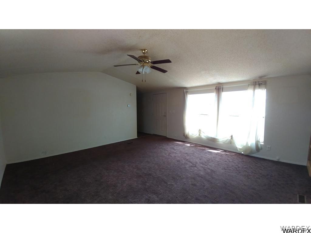 4905 Teddy Roosevelt Road Golden Valley, AZ 86413 - Photo 8 of 29 a open hall with a ceiling fan and window