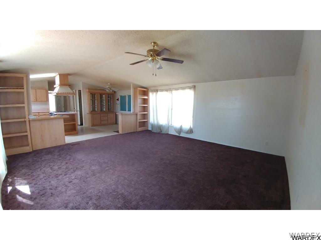 4905 Teddy Roosevelt Road Golden Valley, AZ 86413 - Photo 9 of 29 a living room with furniture and a kitchen