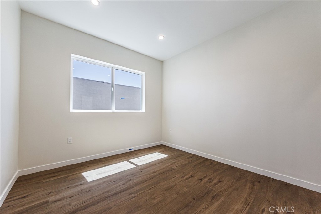 1855 Crenshaw Boulevard Los Angeles, CA 90019 - Photo 16 of 22 a view of empty room with wooden floor and fan