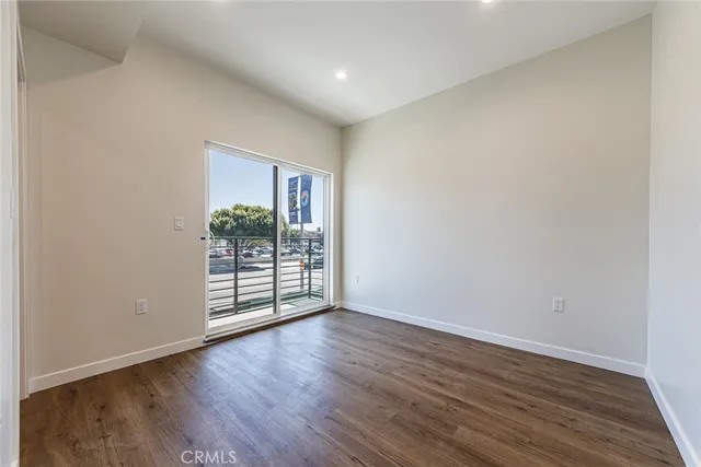 a view of a room with wooden floor and window
