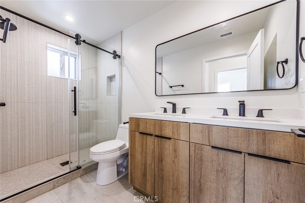 1855 Crenshaw Boulevard Los Angeles, CA 90019 - Photo 22 of 22 a bathroom with a sink a toilet and shower