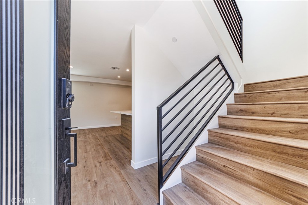 1855 Crenshaw Boulevard Los Angeles, CA 90019 - Photo 5 of 22 a view of a hallway with wooden floor and staircase