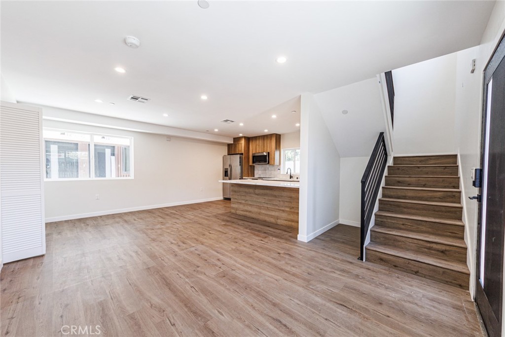 1855 Crenshaw Boulevard Los Angeles, CA 90019 - Photo 6 of 22 wooden floor in an empty room with a window