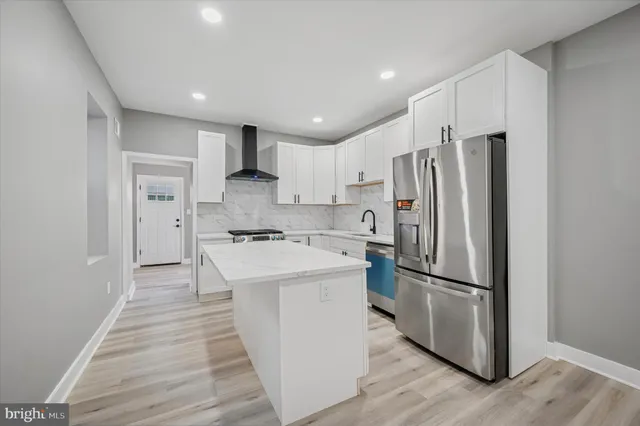 a kitchen with stainless steel appliances a refrigerator sink and microwave