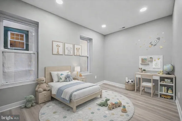 a bedroom with a bed and wooden floor