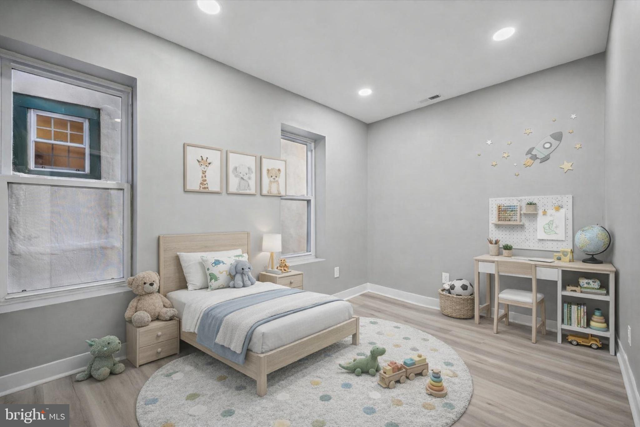 4542 Sansom Street Philadelphia, PA 19139 - Photo 13 of 36 a bedroom with a bed and wooden floor