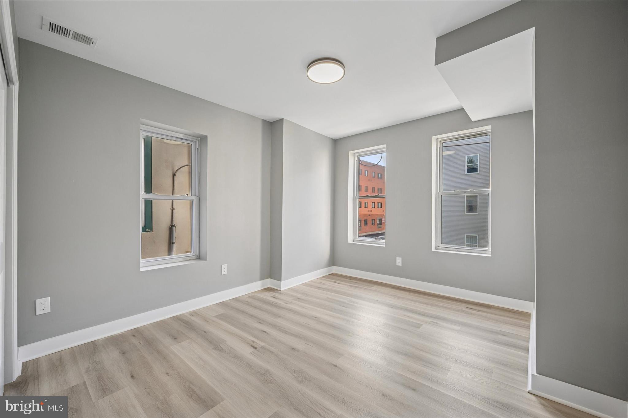 4542 Sansom Street Philadelphia, PA 19139 - Photo 14 of 36 a view of an empty room with window and wooden floor