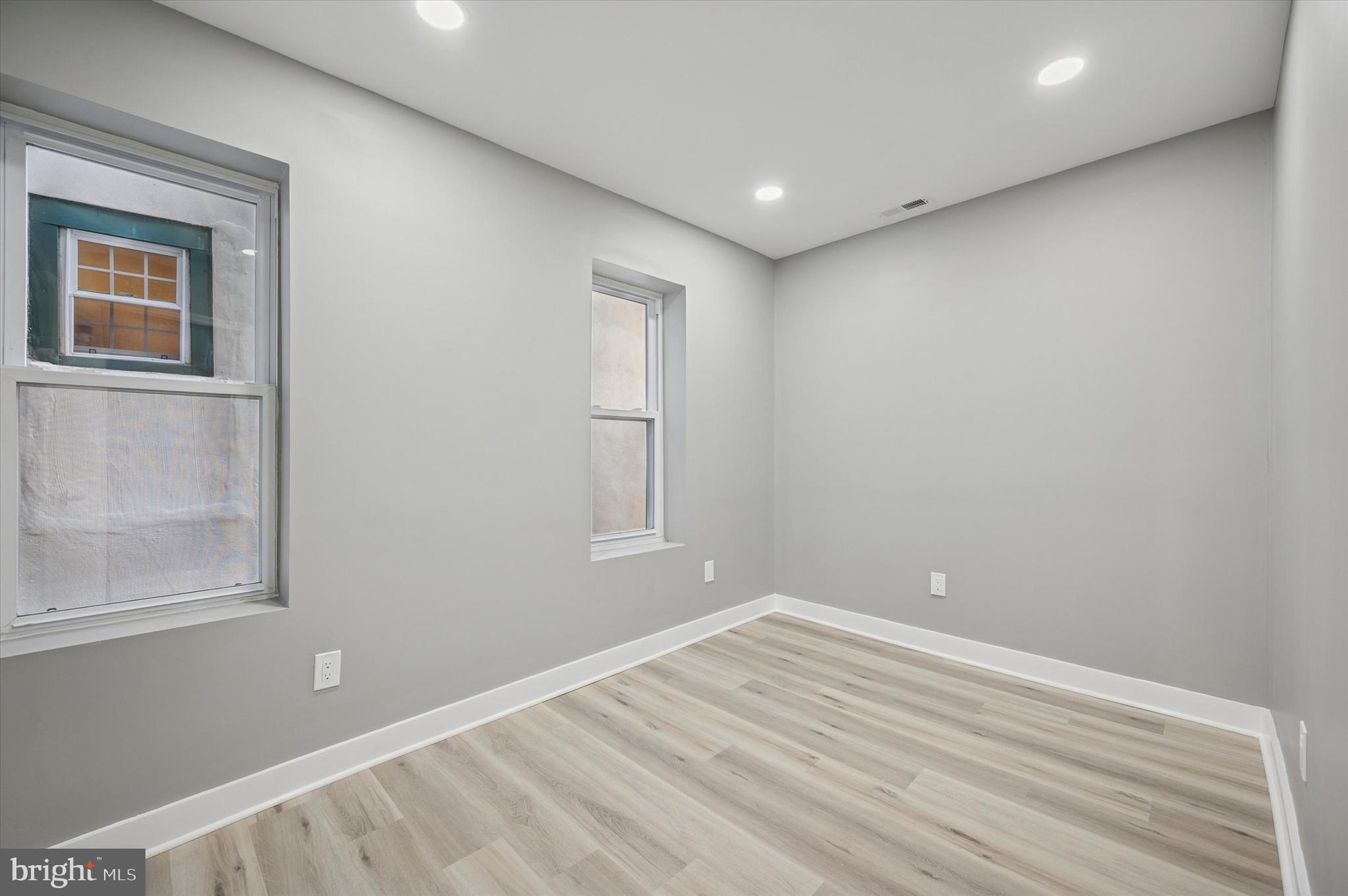 4542 Sansom Street Philadelphia, PA 19139 - Photo 16 of 36 a view of empty room with window and wooden floor