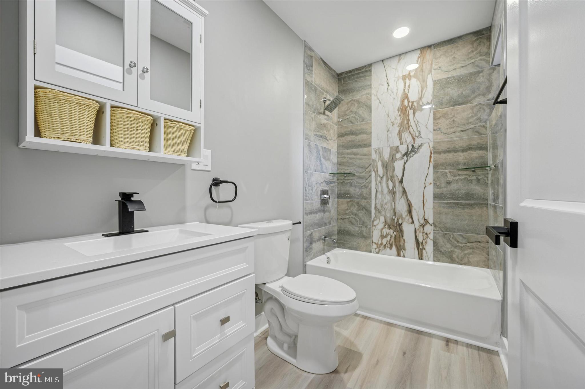 4542 Sansom Street Philadelphia, PA 19139 - Photo 22 of 36 a bathroom with a sink a toilet and shower