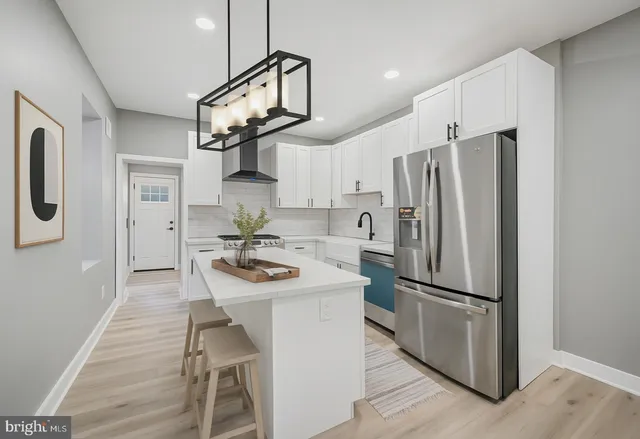 a kitchen with stainless steel appliances a refrigerator and a stove