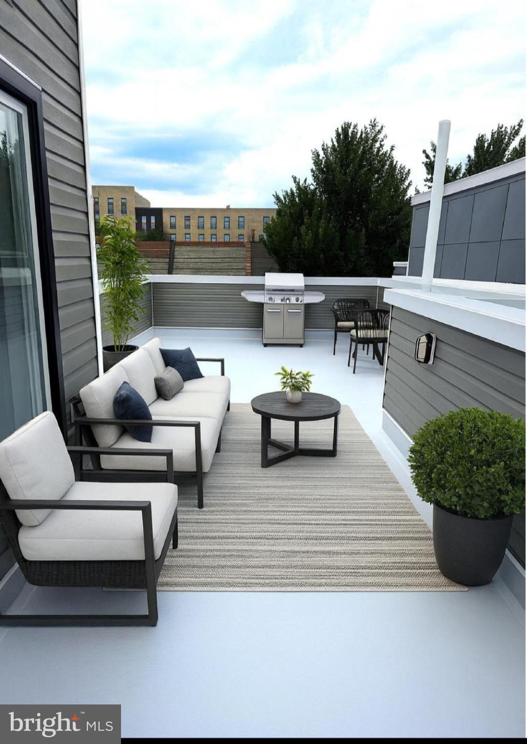 4542 Sansom Street Philadelphia, PA 19139 - Photo 31 of 36 a roof deck with couches and potted plants