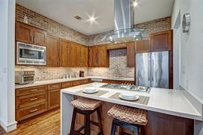 5407 Jackson Street Houston, TX 77004 - Photo 9 of 24 a kitchen with a table chairs stove and refrigerator