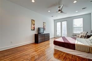 5407 Jackson Street Houston, TX 77004 - Photo 15 of 24 a bedroom with a bed and wooden floor