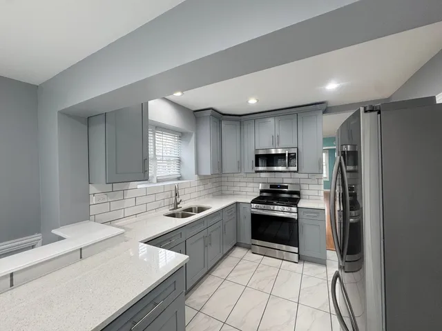 a kitchen with a sink stainless steel appliances and cabinets