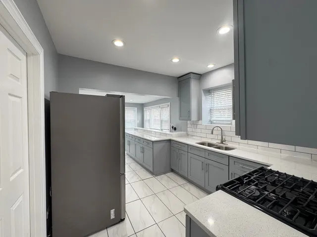 a kitchen with a sink a stove and refrigerator