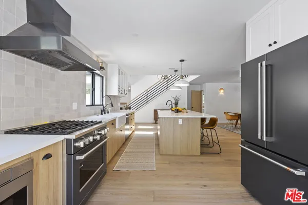 a kitchen with a table chairs stove and cabinets