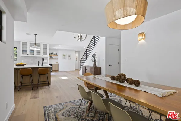 a view of a dining room with furniture and a chandelier