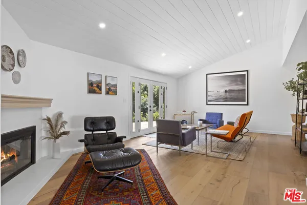 a living room with furniture a dining table and a potted plant