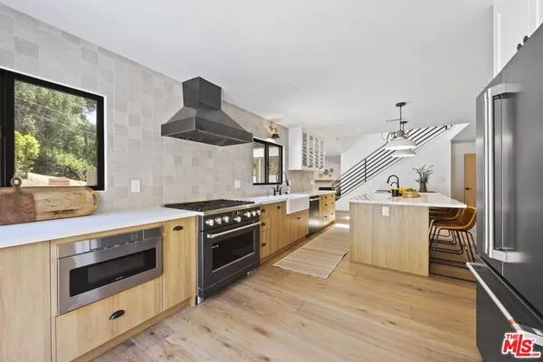 a kitchen with a stove and a refrigerator