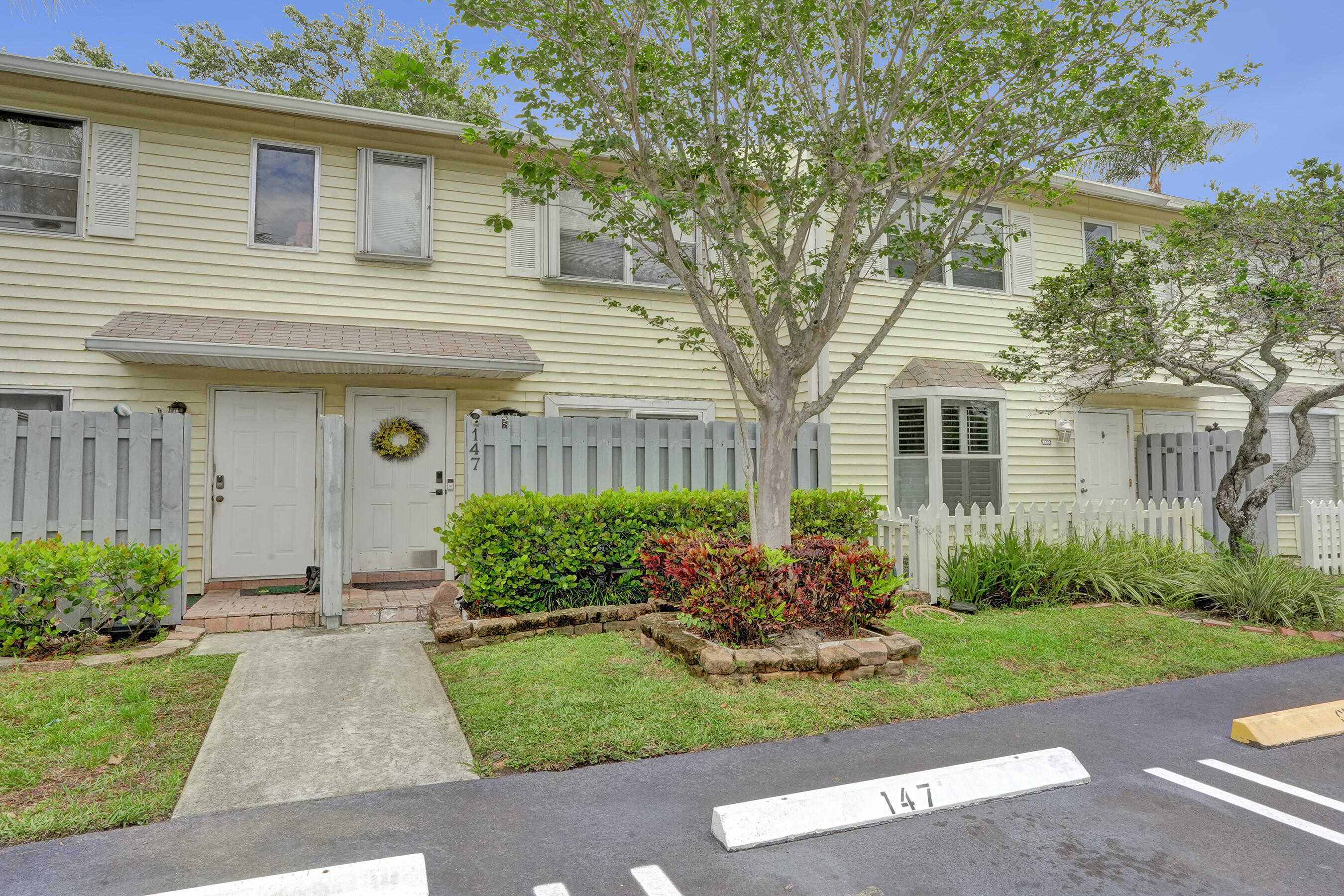 147 Southwest 3rd Street Pompano Beach, FL 33060 - Photo 13 of 29 a front view of a house with a yard and potted plants
