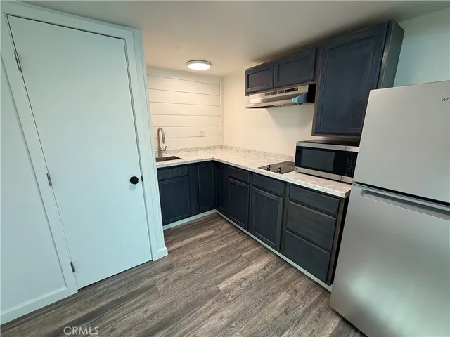 a kitchen with a refrigerator and a sink