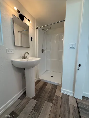 a bathroom with a sink a mirror and shower