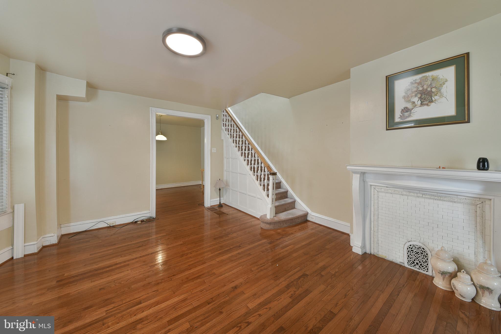 5331 Race Street Philadelphia, PA 19139 - Photo 3 of 21 a view of an empty room with wooden floor and stairs