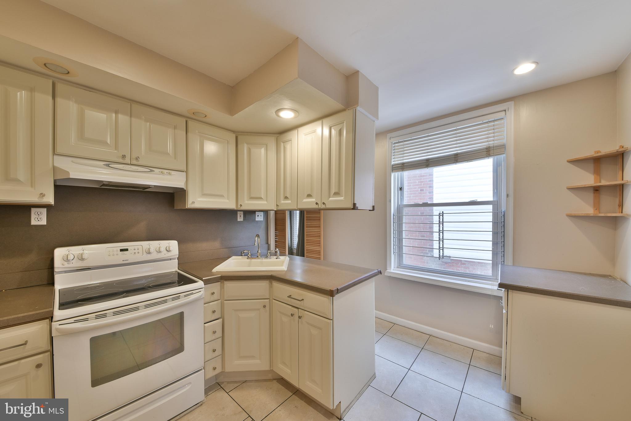 5331 Race Street Philadelphia, PA 19139 - Photo 7 of 21 a kitchen with white cabinets and white appliances