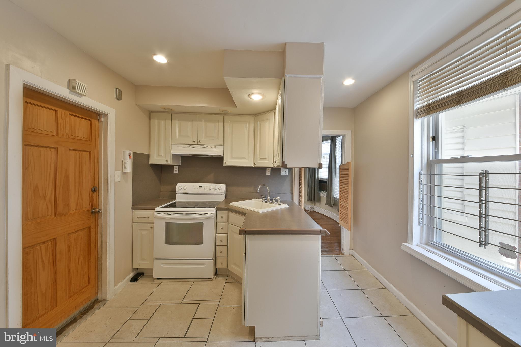 5331 Race Street Philadelphia, PA 19139 - Photo 8 of 21 a kitchen with stainless steel appliances granite countertop a stove a sink and a refrigerator