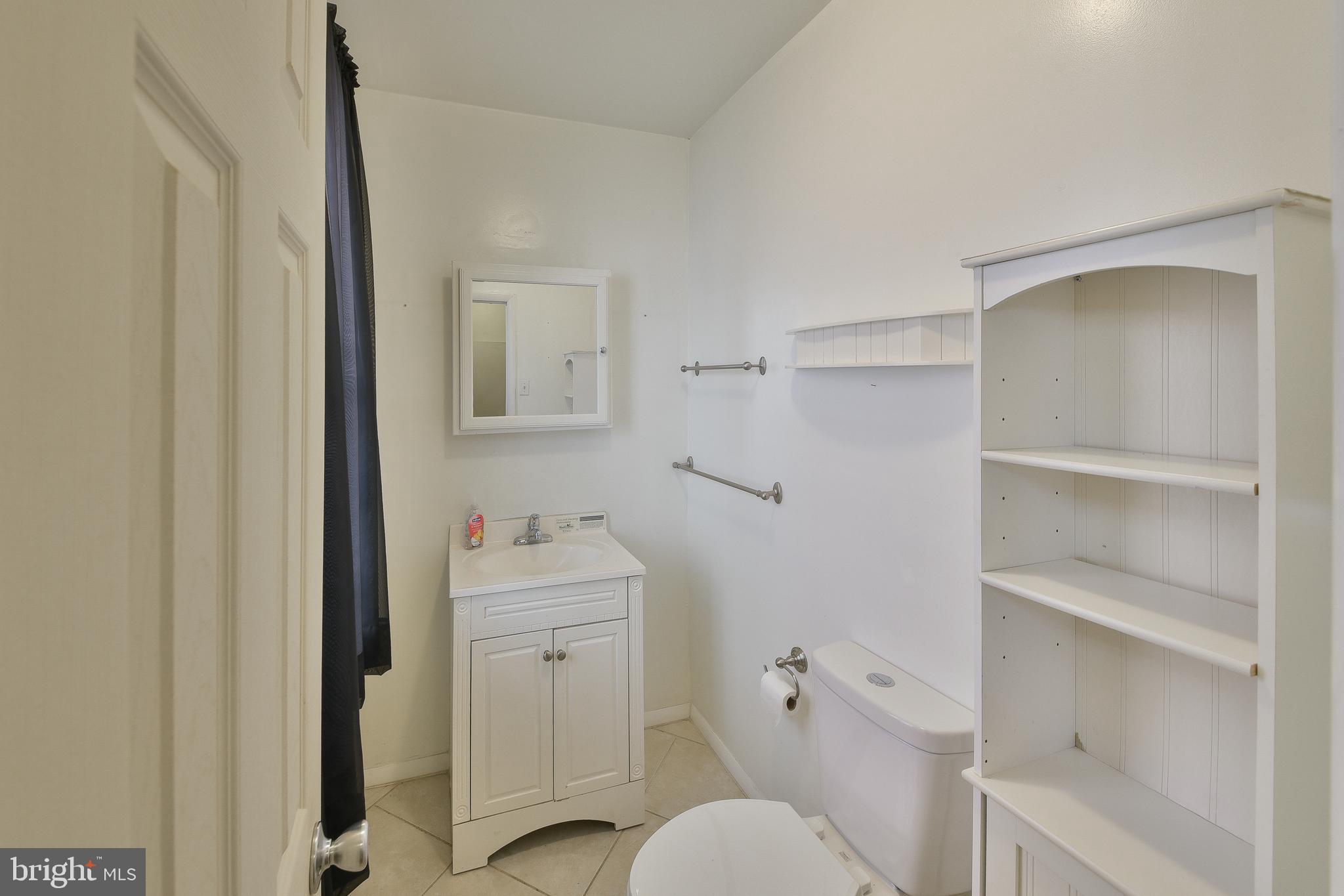 5331 Race Street Philadelphia, PA 19139 - Photo 10 of 21 a bathroom with a sink a toilet and a mirror